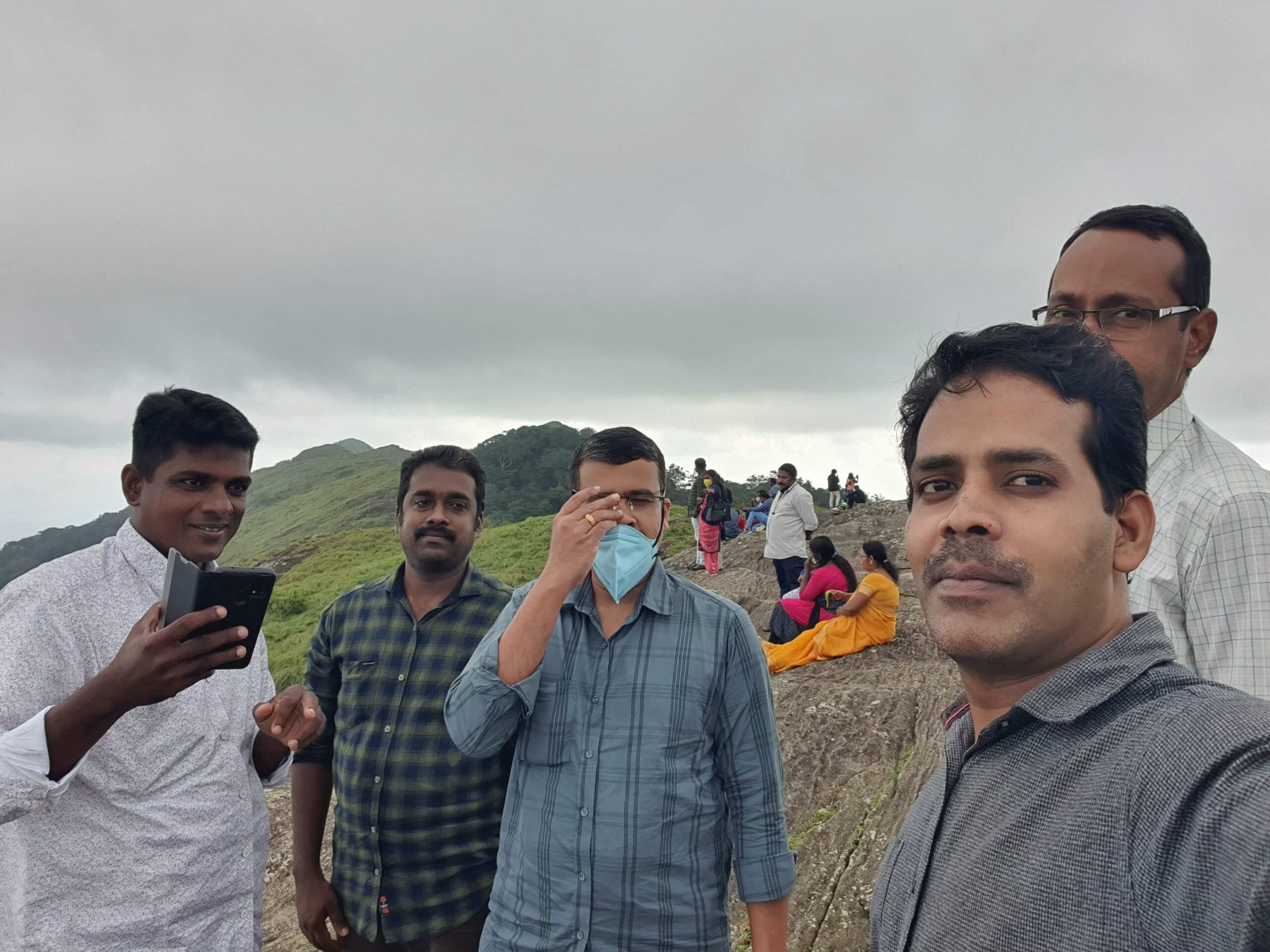 Group photo at the starting point of the journey, everyone smiling with travel bags